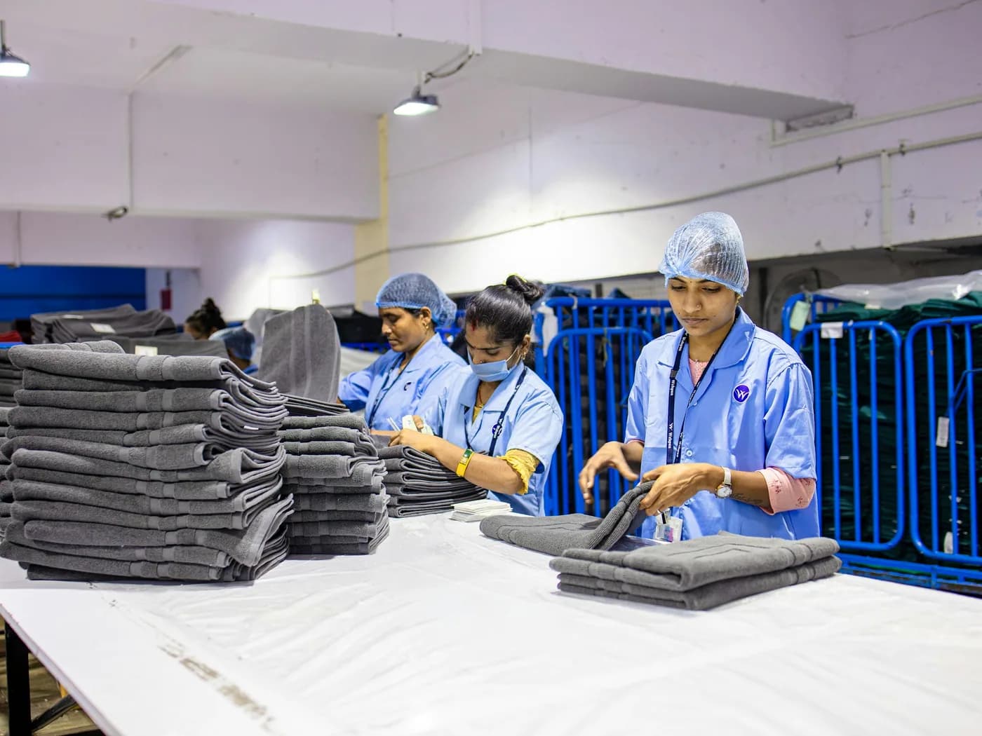 Clean laundry being sorted and folded at a work table